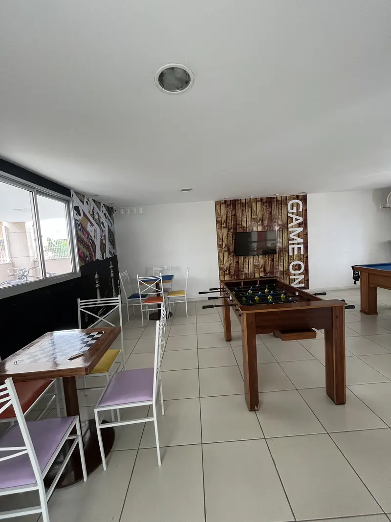 Salão de jogos com pebolim e mesas